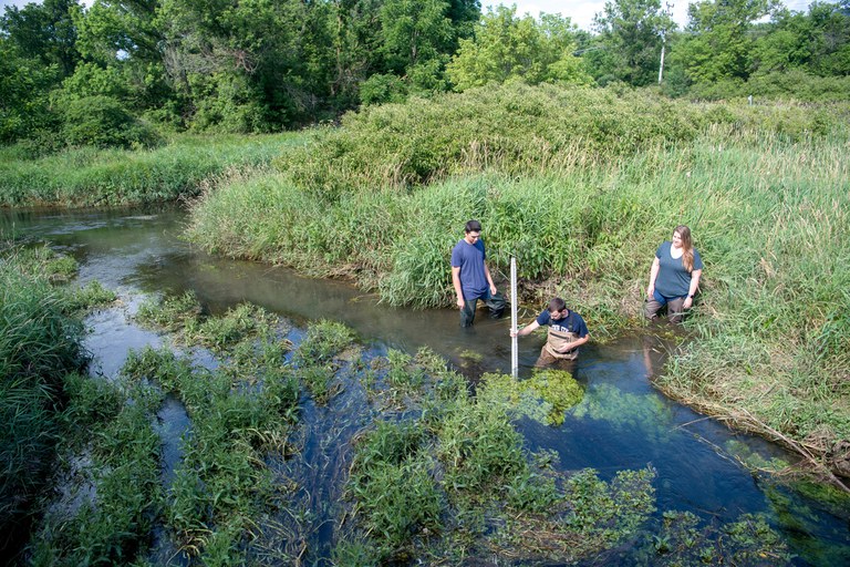 Penn State students measuring stream depth.