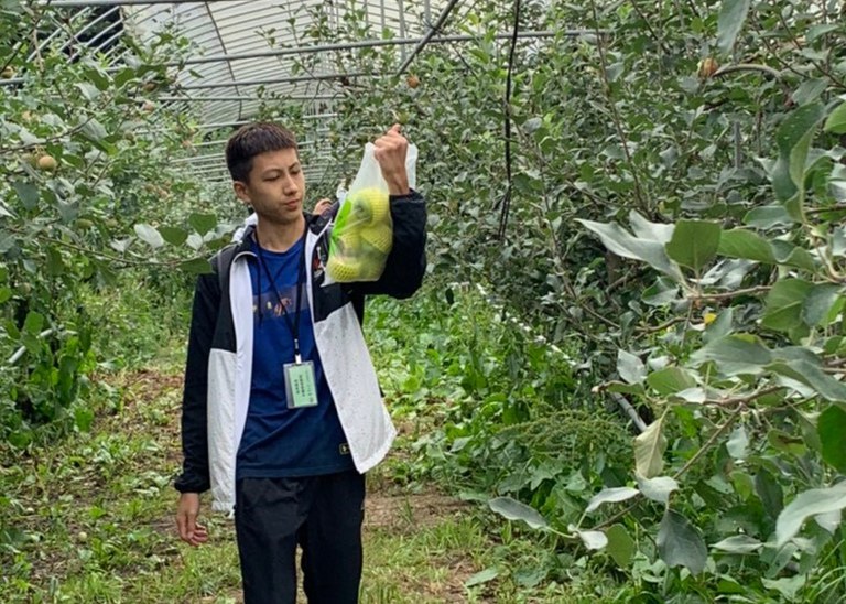 Jason Huang holding fruit