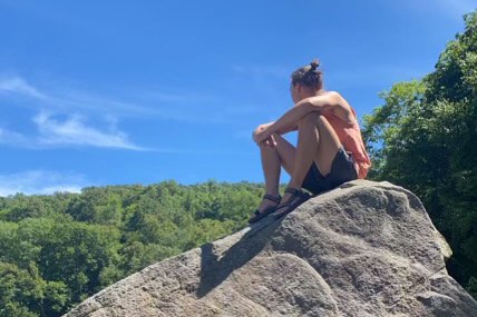 Logan sitting on a rock