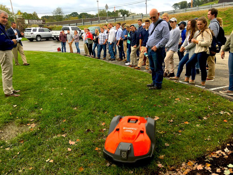 Agribusiness management students get an up-close look at autonomous lawn mowers on a visit to Eichenlaub, Inc., an upscale landscape services firm in Pittsburgh. Students are helping Eichenlaub evaluate the mowers. (Photo by Angela Barr)