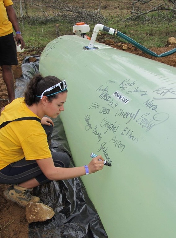 Signing our names on the biodigester we built for a local farmer.