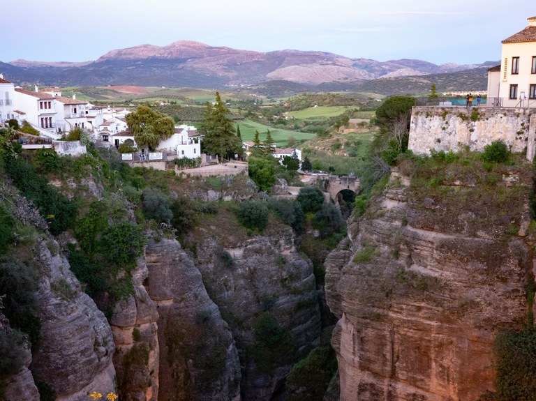 The view of El Tajo, the gorge running through the city of Ronda, with a view of the Sierra de las Nieves in the background.