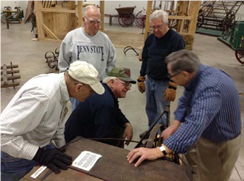 Volunteers discuss regular maintenance schedules and checklists to put in place for large artifact maintenance.
