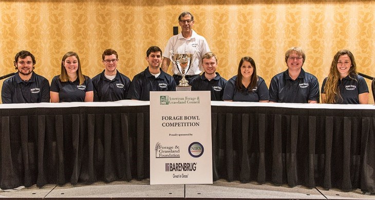 The Penn State 2018 American Forage Bowl team includes, from left, Glenn Travis, Casey Baxter, Jonathan Stephens, Zachary Curtis, Cullen Dixon, Taylor O’Guinn, Ben Crusan and Sunnie Liggett. Standing is Marvin Hall, professor of forage management.