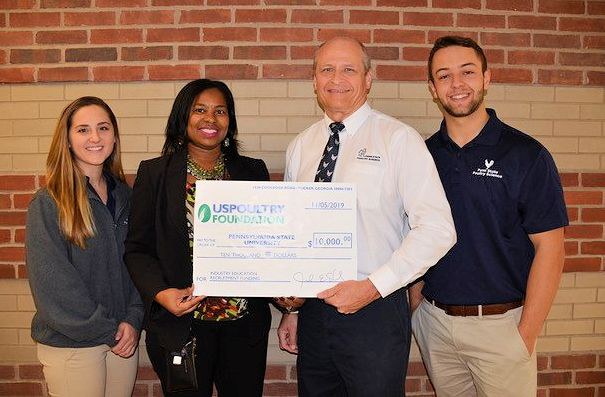 Barbara Jenkins, vice president of education and student programs for USPOULTRY and executive director of the USPOULTRY Foundation, second from left, presents a check for $10,000 to Penn State’s Phillip Clauer.  Poultry Science Club Vice President Lindsey Bright is on the left; President Ethan Metzler is on the right.